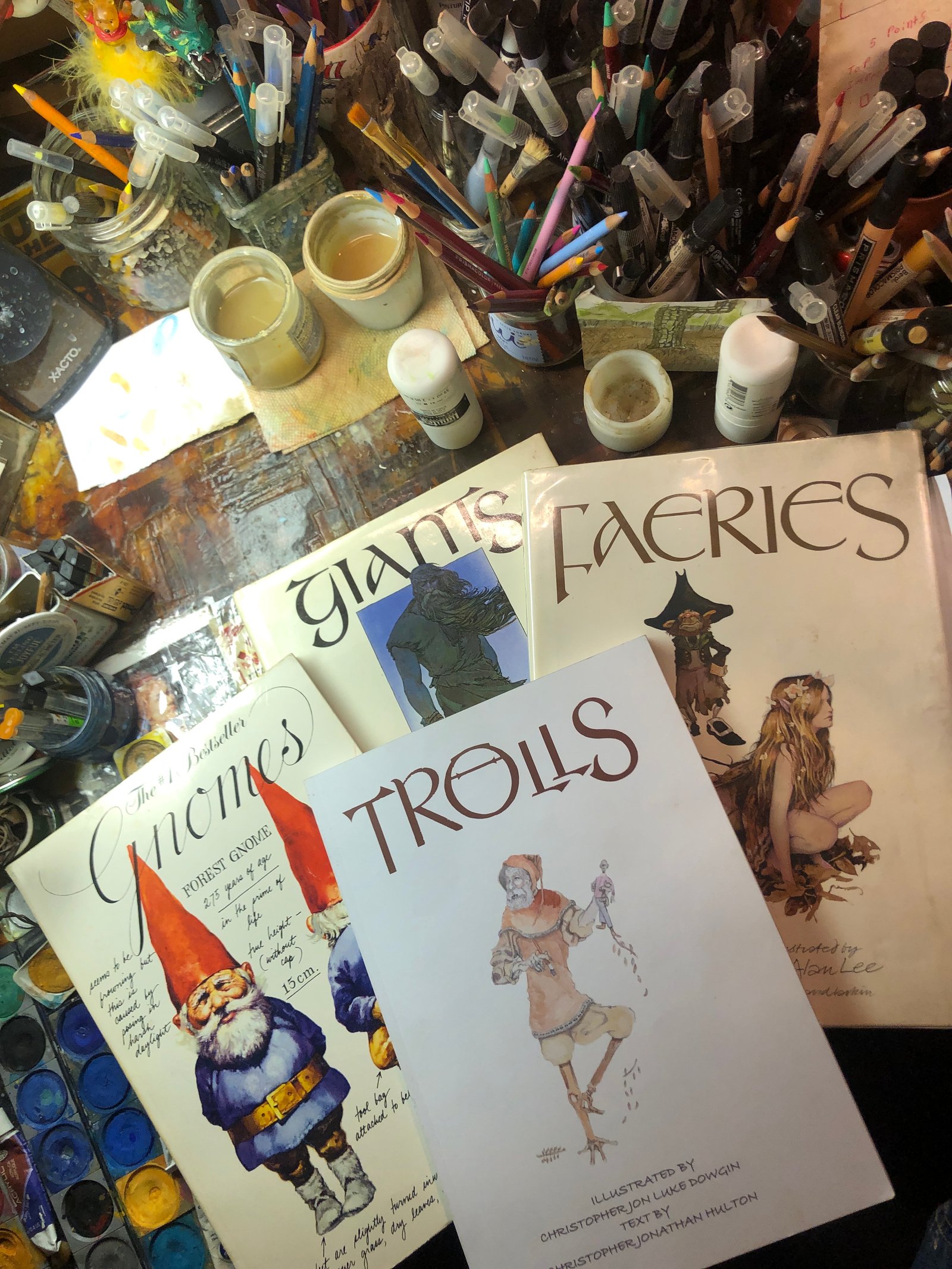 Gnomes, Giants, and Trolls books on artist desk.